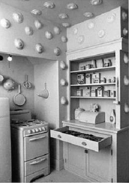 <i>Kitchen</i>, by Robin Welsch in <i>Womanhouse</i> included eggs as symbols of breasts on the wall to showcase how a woman's identity was submerged within the domestic scene - in her role as wife and maid