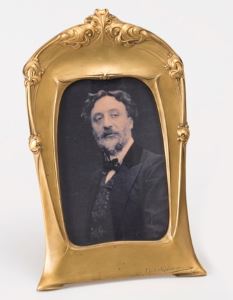 Guimard's portrait in a frame he designed, an example of his decorative art that is frequently found in museums today