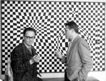 Victor Vasarely (left) in front of one of his <i>Vega</i> series paintings with the Czech-born Argentine sculptor Gyula Kosice (1958)