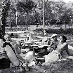<i>Picnic at Mougins</i>. A group Miller's friends (left to right, clockwise: Nusch Eluard, Paul Eluard, Roland Penrose, Man Ray, Ady Fidelin) pose in imitation of Manet's <i>Dejeuner Sur l'Herbe</i> during a “Surrealist picnic” in the summer of 1937. Lee Miller Archives