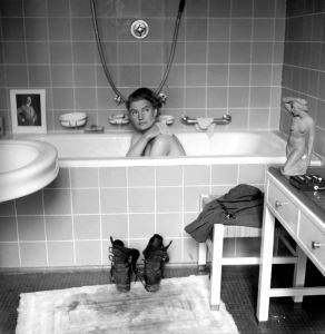 <i>Lee Miller in Hitler's Bathtub</i> (1945). Miller and LIFE photographer David Scherman were practically inseparable during the War. They staged this photograph while staying in Eva Braun's house, purposefully setting her boots - covered in mud from their recent assignments at concentration camps - on the fluffy white bathmat. LIFE Picture Collection/Getty Images, by David E. Scherman