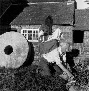 Miller's photograph <i>Dorothea Tanning and Max Ernst, Farley Farm</i> (1953). For her final photo essay published in <i>Vogue</i>, Miller put her art world friends to work around her farm. Surrealist artist Max Ernst, here, planting petunias, introduced Miller to her second husband, Roland Penrose, in 1937
