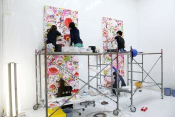 This photograph of the KaiKai Kiki Company shows a number of artists working on two of Murakami's artworks.