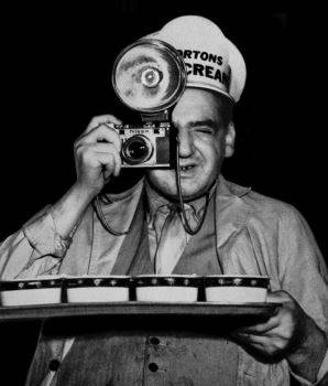 Weegee reenacting how he did his infrared flash theatre photography, disguised as an ice cream vendor