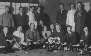 Wright (seated, center) and his American and Japanese office staff and colleagues at a party at the previous Imperial Hotel, Tokyo (1920)