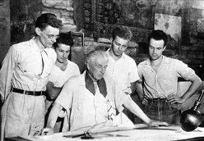 Wright and four of his apprentices at a drafting table at Taliesin (1938)