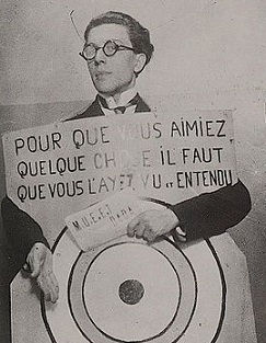 André Breton in 1920, at a Dada festival in Paris wearing a sign designed by Francis Picabia