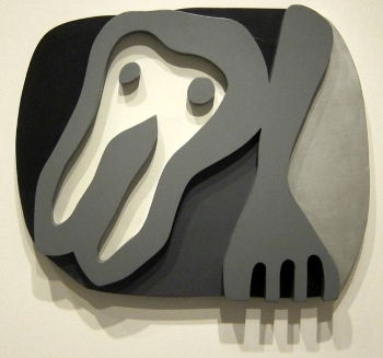 In Hans Arp's <i>Shirt Front and Fork</i> (1922), a wood relief, painted in black, white, and grey, curvilinear lines and organic forms are emphasized.