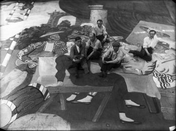 Pablo Picasso and scene painters sitting on the front cloth for the ballet Parade at the Théâtre du Châtelet, Paris, 1917