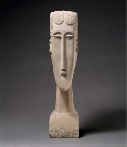 Influenced by Baule masks from Africa, Amedeo Modigliani's <i>Woman's Head</i> (1912) shows his distinctive style for which his paintings are famously known.