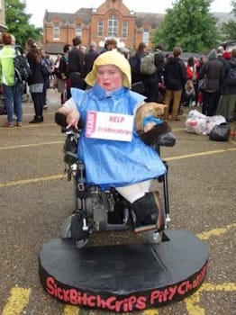 Katherine Araniello dressed as a Spastic Society collection tin in a performance from her film <i>Pity</i>.