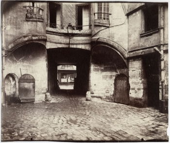 Eugène Atget's <i>La cour du Dragon (Paris Vie)</i> (1913) shows an inner courtyard in old Paris, dating back to medieval times.
