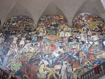Diego Rivera's <i>The History of Mexico</i> mural at the National Palace (1935) is an example of the Mexican Muralism Movement that started in the 1920s and mainly focused on realistic representation of national values.