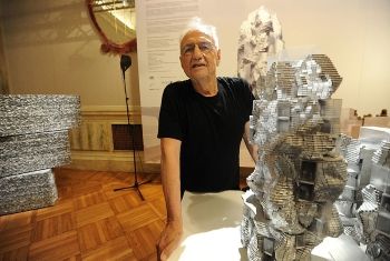 Gehry with a model of his Parc des Ateliers (2010)