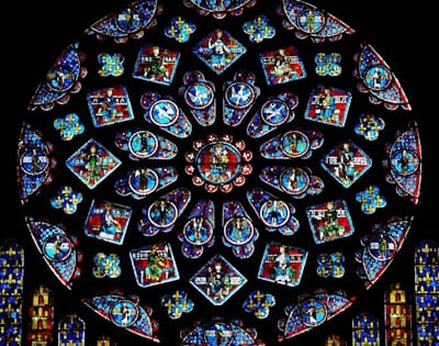 The North Rose Window of the Chartres cathedral in France dates to c. 1231 and bears the theme of the Old Testament prophecies being fulfilled, with Mary as their instrument.