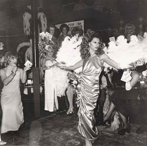 Naomi, a drag queen Goldin often photographed in Boston, modelling in a beauty parade with fans (1974)