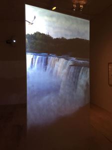 In Angie Kiefer's <i>Fountain</i> (2014) data from commodity prices is used to control the rear projection of the Niagara Falls image
