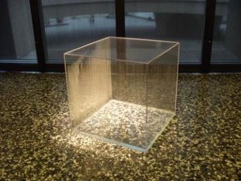 This photograph shows Hans Haacke's <i>Condensation Cube</i> (1963), a Minimalist Plexiglas cube in which the hydrological cycle occurs, as seen in the mist beading on one side of the container.