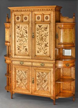 <i>Harmony in Yellow and Gold - The Cloud Cabinet</i> (ca. 1878) was designed by Godwin and painted by Whistler, who added golden clouds of butterflies on the doors of the side cabinets.