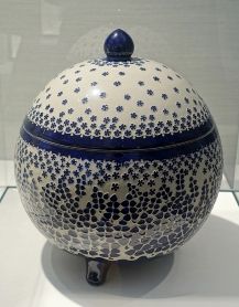 Richard Riemerschmid's Covered bowl (1902) combines a simple geometric volume with an almost abstract blue and white pattern, its shapes reminiscent of leafs, small stones, flowers, or stars.