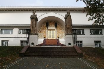 Joseph Maria Olbrich's Ernst Ludwig House (1900), built as a community studio and surrounded by artists' residences, included art works by Peter Behrens and Paul Bürck, as well as Ludwig Habich's two monumental statues shown here.