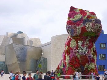 <i>Puppy</i> (1992) is a huge living sculpture of a West Highland Terrier. Created as a symbol of love and happiness, like much of Koons' work, it also functions as a comment on capitalist and consumerist excess