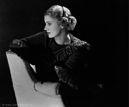 <i>Miss Lee Miller (Coiffure by Dimitry)</i> (1933). During her early years as a photographer, Miller continued to model for Vogue, here modelling a <i>coiffure</i> that mirrors the dense pleats of her dress