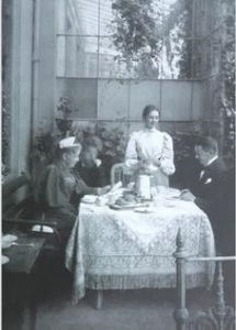 Photograph of artist Paula Modersohn-Becker's parents Carl Woldemar Becker and Mathilde Becker dining in the conservatory of their home in Bremen, Germany. The image was taken some time prior to 1901.