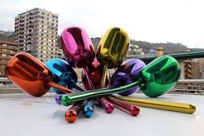 Jeff Koons' massive stainless steel sculpture <i>Tulips</i> (1995-2004) is both kitsch (in its gaudiness and lack of conceptual depth) and camp (in its flamboyance and exaggeration of size).