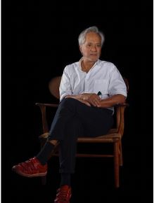<i>Anish</i> (2017) Opie said when taking this portrait of the British sculptor, she tried to imagine how David Hockney would paint him. “So I did something that I never do in my work, but that David would, which is to cut off the tip of a shoe.”