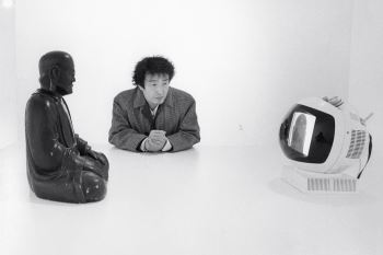 Nam June Paik with Buddha TV (1974). Photograph by Eric Kroll