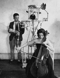 Nam June Paik with Charlotte Moorman Paik's Lispenard Street studio (Aug 17, 1964). Photograph by Peter Moore