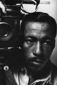An early self-portrait of Parks with a vintage flash-bulb camera (1946)