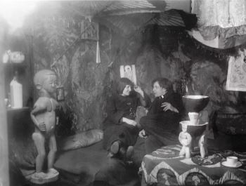 Ernst Ludwig Kirchner and Erna Schilling in Kirchner's Berlin studio, c. 1912-14, surrounding by textiles and African sculpture.