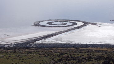 Robert Smithson's earthwork <i>Spiral Jetty</i> (1970) involved the construction of a 1,500-foot-long and fifteen-foot-wide spiral, from 6,000 tons stones, algae, and other organic materials in Utah's Great Salt Lake. Smithson accepted that natural forces would take over the work, as in 1972, the work became submerged by the raising water level, until it was revealed again three decades later, now crusted over with white salt.