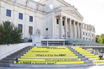 The steps of the Brooklyn Museum painted with some of the recurring questions that were discussed during Suzanne Lacy's seminal 2013 gender politics piece “<i>Between the Door and the Streets</i>” that took place in a Brooklyyn neighborhood amongst the public.