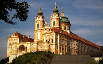 Jacob Prandtauer's Melk Abbey (1702-1736) exemplified the German Rococo use of color and innovations in spatial construction as seen in the rippling front wall, and site location, as the building overlooks the Danube River.