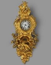 The case of this <i>pendule en cartel</i>, or wall clock, (c. 1740-1745) was designed by Charles Cressent for a clock made by Jean Godde l'aîné.