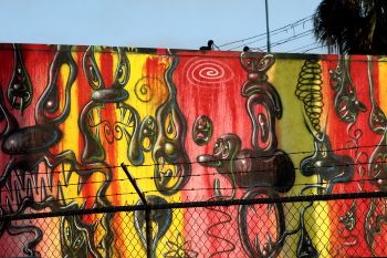 A mural showing Scharf's signature amorphic characters and psychedelic colors.