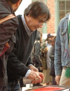 Blek le Rat (Xavier Prou) spray painting his signature on his book for fans. (2011)