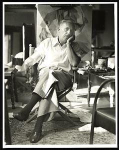 Robert Bruce Inverarity's photograph of Stanton Macdonald-Wright (1948) shows the artist in his California studio in front of a painting in his later style, which combined representational elements, rendered in a naturalistic style, with a Synchromist background