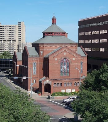 American Theosophist and architect Claude Bragdon espoused a Theosophical vision of architectural design, blending Eastern and Western elements, and seeking to foster societal harmony, through his building designs like the First Universalist Church in Rochester, New York (1907-08).