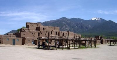 Taos Pueblo, photo taken in 2005. Taos Pueblo, especially with its historic adobe structures, offers a picturesque contrast against the natural beauty of the surrounding terrain.