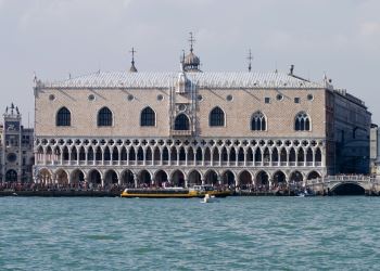 This photograph of the Doge's Palace, located in the Piazza San Marco, in Venice shows the arches and delicate tracery that exemplified the Venetian Gothic style.