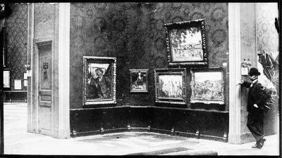 Vollard took this photograph of the 1904 Salon d'Automne. The room featured was dedicated to the works of Paul Cézanne and the man leaning against the wall was French art collector Victor Chocquet.