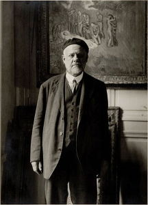 Edmond Bénard's photograph of Vollard standing in front of Pablo Picasso's <i>Evocación. El entierro de Casagemas</i> (1901) which is now in the collection of the Musée d'Art Moderne de la Ville de Paris.