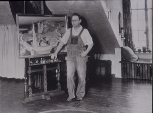 Grant Wood in his signature ensemble, in his studio, with <i>The Midnight Ride of Paul Revere</i>, 1931, Cedar Rapids Art Museum Archives