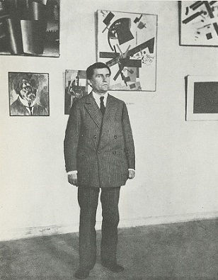Kazimir Malevich surrounded by his works at an exhibition